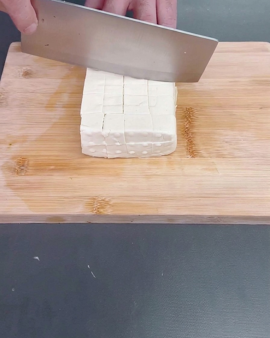 Świeżo obrana luffa krojona w nieregularne kawałki metodą roll-cut.