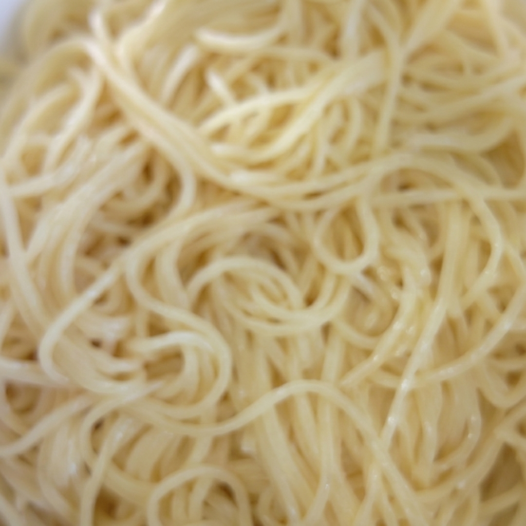 Miska ugotowanego makaronu spaghetti mieszanego z olejem.
